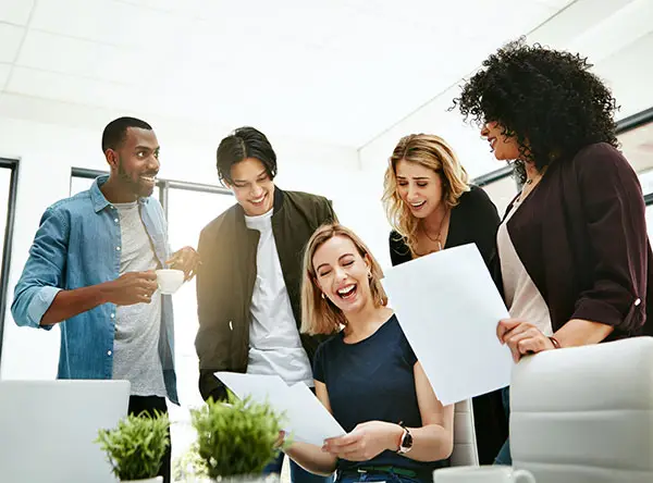 People standing around a table and computer